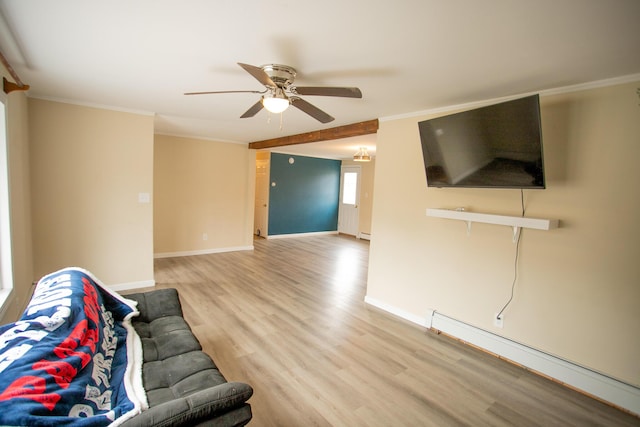 unfurnished living room with baseboard heating, light wood-style floors, ceiling fan, and baseboards