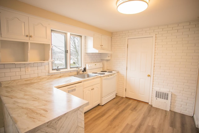 kitchen featuring white appliances, white cabinetry, a sink, and backsplash