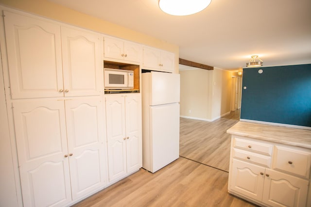 kitchen with baseboards, white appliances, light countertops, white cabinets, and light wood-style floors