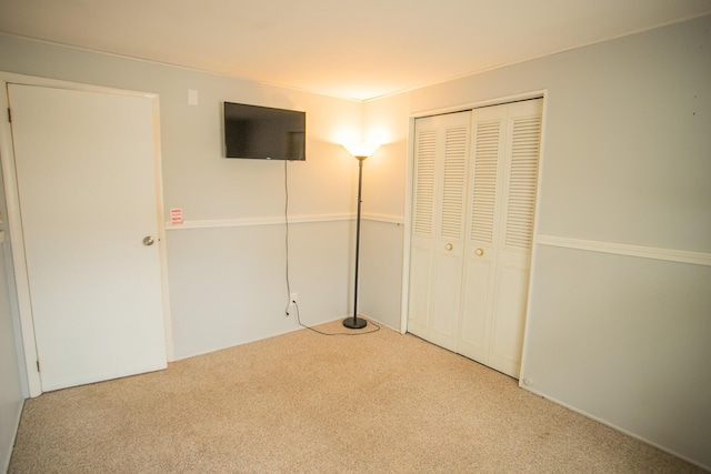 unfurnished bedroom featuring a closet and carpet