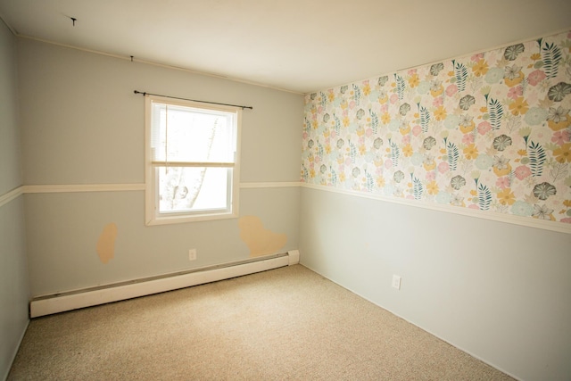 empty room featuring baseboard heating and carpet flooring