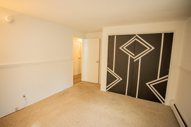 spare room with carpet floors and baseboard heating