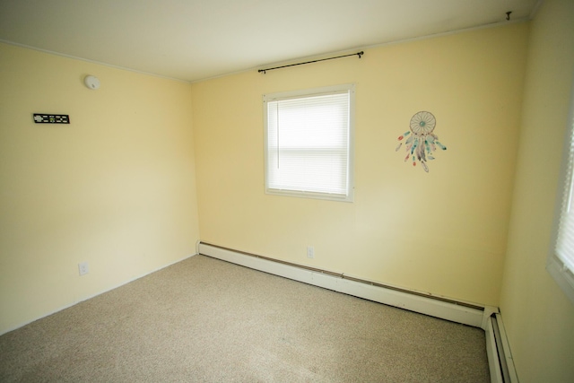 spare room featuring baseboard heating, a baseboard heating unit, and carpet