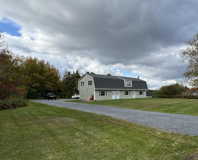 19 Dirigo Rd, China, ME 04358 - view of side of property featuring a yard, gravel driveway, a gambrel roof, and a shingled roof