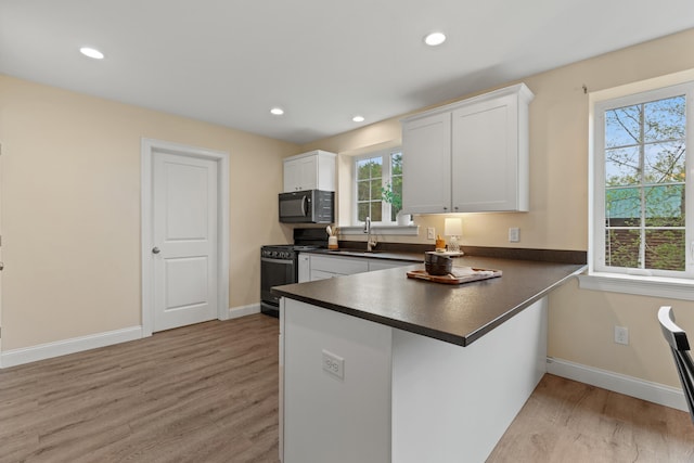 4 Peaceful Way, Windham, ME 04062 - kitchen featuring gas range, black microwave, dark countertops, a sink, and light wood-type flooring