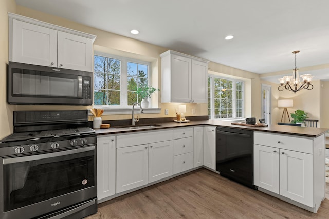 4 Peaceful Way, Windham, ME 04062 - kitchen featuring stainless steel gas range, black dishwasher, a sink, dark countertops, and light wood-style floors