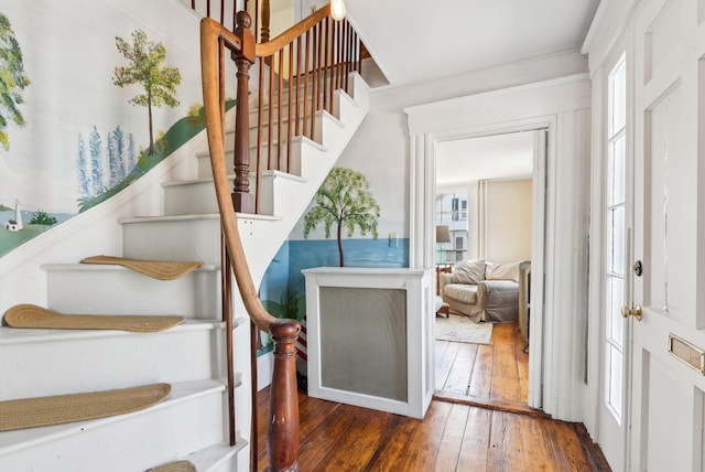 stairway with hardwood / wood-style floors and plenty of natural light