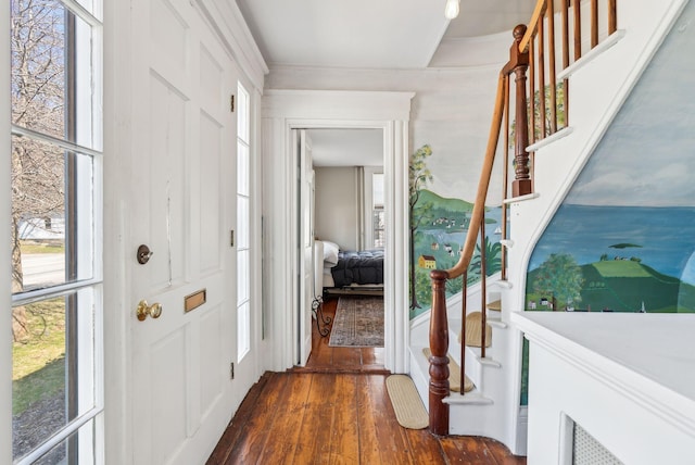 entrance foyer featuring stairway, crown molding, dark wood-style floors, and plenty of natural light