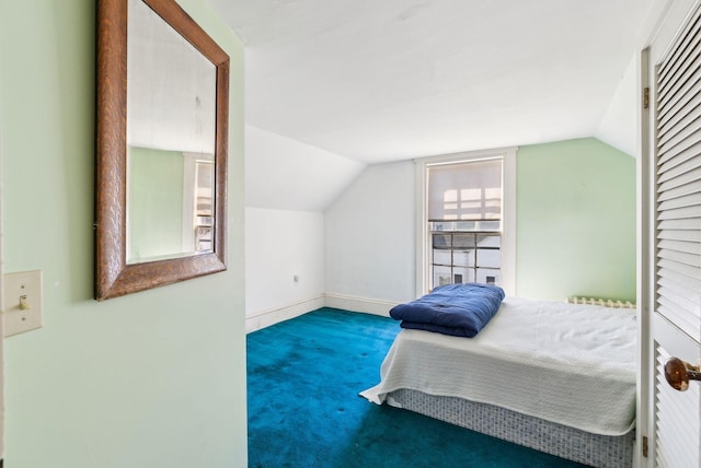 carpeted bedroom featuring vaulted ceiling and baseboards
