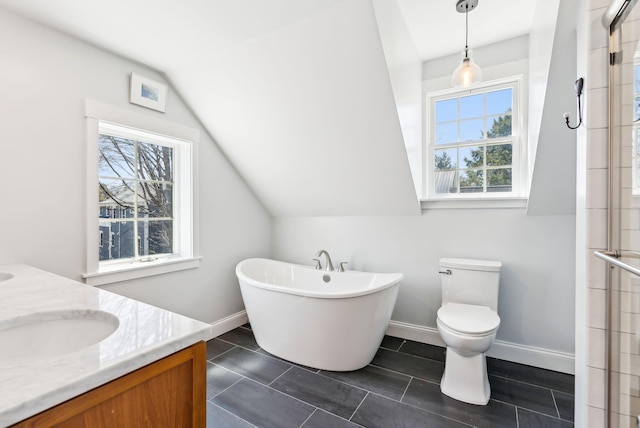 bathroom with a freestanding tub, vanity, a tile shower, toilet, and lofted ceiling