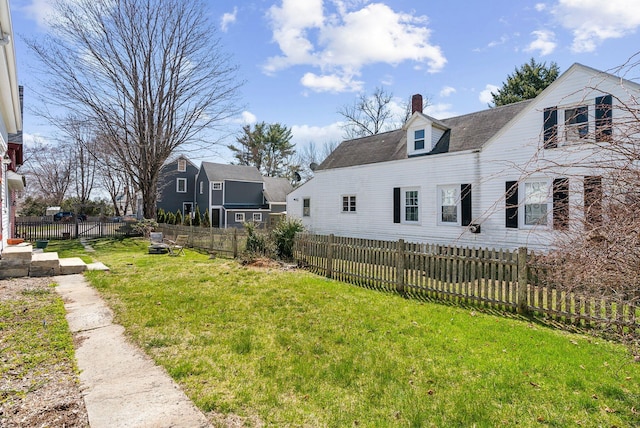 exterior space featuring fence private yard, a lawn, and a chimney
