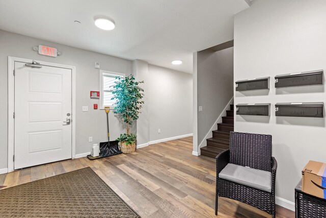 8 College Ave, Gorham, ME 04038 - entrance foyer featuring baseboards, wood finished floors, and stairway