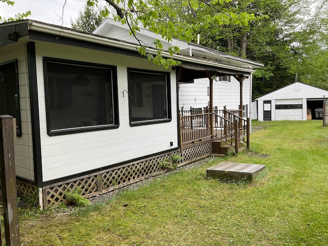 360 Garland Rd, Dexter, ME 04930 - view of side of property with a yard, an outbuilding, and a detached garage