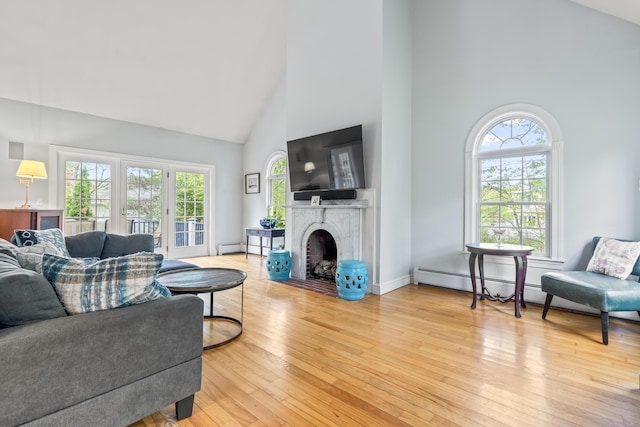 10 Thistleberry Ln, York, ME 03909 - living room with high vaulted ceiling, a fireplace with flush hearth, and light wood-style flooring