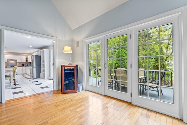 10 Thistleberry Ln, York, ME 03909 - doorway featuring vaulted ceiling, light wood-type flooring, and wine cooler