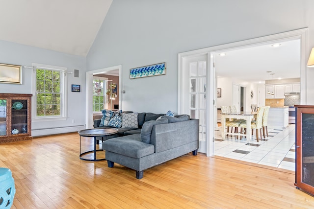 10 Thistleberry Ln, York, ME 03909 - living room featuring baseboard heating, light wood finished floors, and high vaulted ceiling