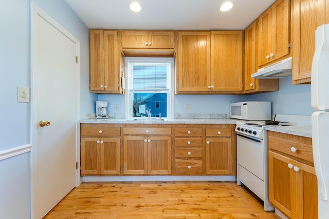 58 Shelton Dr, York, ME 03909 - kitchen featuring under cabinet range hood, light countertops, a sink, white appliances, and light wood-style flooring