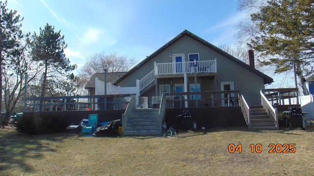 8 Prince St, Lincoln, ME 04457 - back of house with a balcony, a lawn, and stairway