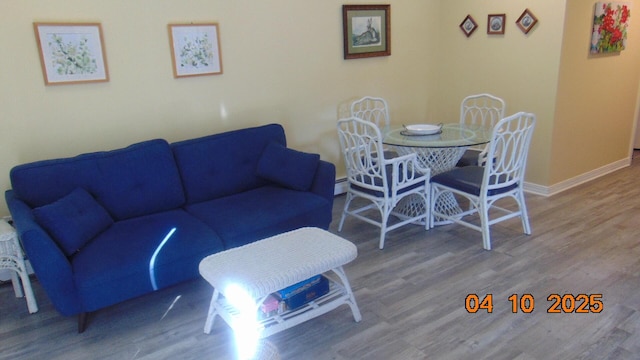 8 Prince St, Lincoln, ME 04457 - living room with baseboard heating, baseboards, and wood finished floors