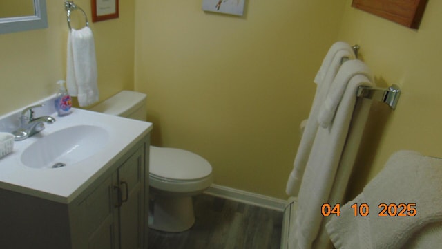 8 Prince St, Lincoln, ME 04457 - bathroom with toilet, vanity, wood finished floors, and baseboards