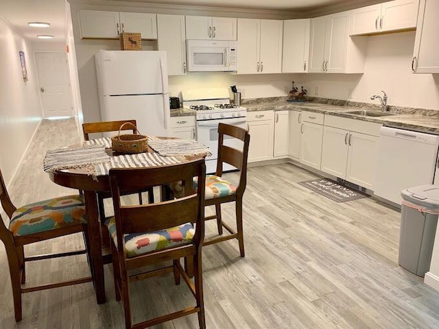 8 Prince St, Lincoln, ME 04457 - kitchen featuring white appliances, light wood-type flooring, white cabinets, a sink, and baseboards