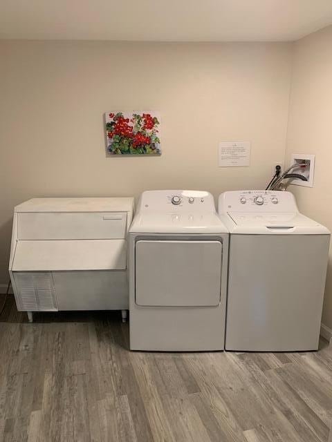 8 Prince St, Lincoln, ME 04457 - laundry room with wood finished floors, washer and clothes dryer, and laundry area