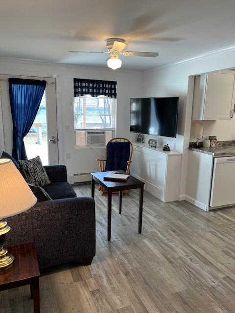 8 Prince St, Lincoln, ME 04457 - living area featuring crown molding, cooling unit, ceiling fan, light wood-style flooring, and baseboards