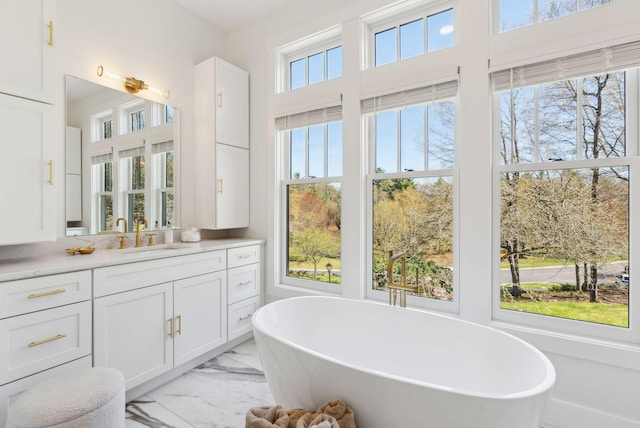 239 Hunter Way, Falmouth, ME 04105 - bathroom with marble look tile flooring, vanity, and a freestanding bath