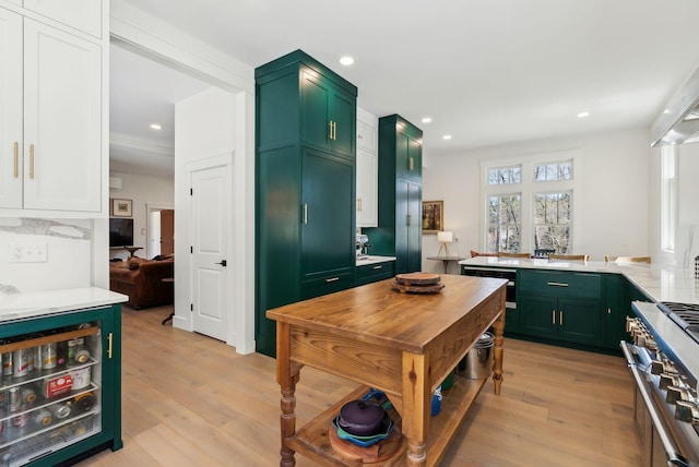 239 Hunter Way, Falmouth, ME 04105 - kitchen with green cabinetry, stainless steel range, light countertops, and recessed lighting
