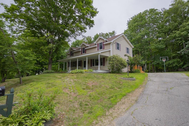 23 Orr St, Wilton, ME 04294 - view of front facade with covered porch, a front lawn, and driveway