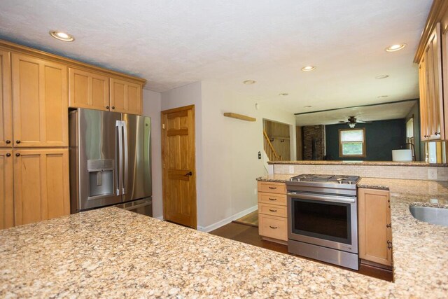 23 Orr St, Wilton, ME 04294 - kitchen with appliances with stainless steel finishes, light stone counters, recessed lighting, and dark wood-type flooring