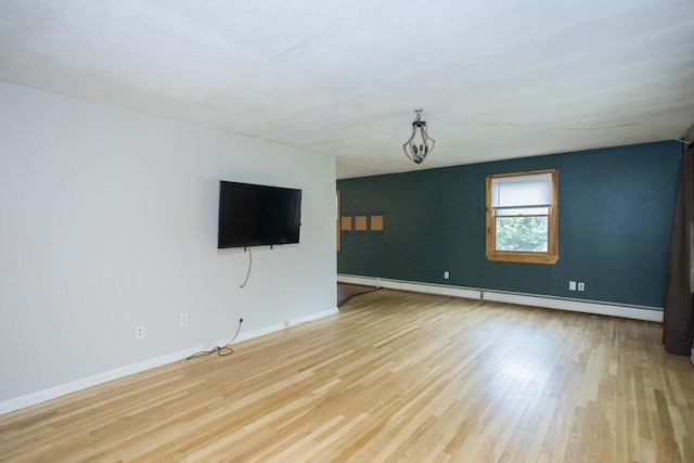 23 Orr St, Wilton, ME 04294 - unfurnished living room featuring a baseboard heating unit and wood finished floors