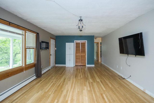 23 Orr St, Wilton, ME 04294 - unfurnished living room featuring a baseboard radiator and light wood-style floors