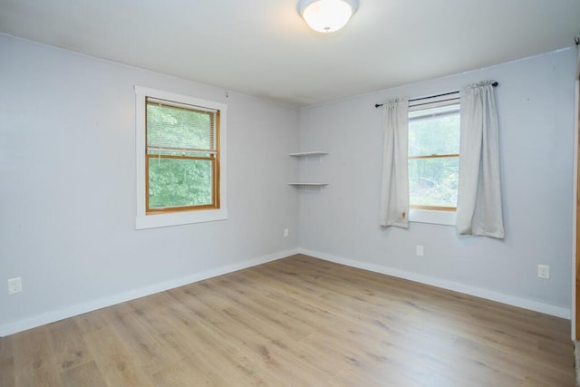 23 Orr St, Wilton, ME 04294 - empty room featuring healthy amount of natural light and wood finished floors