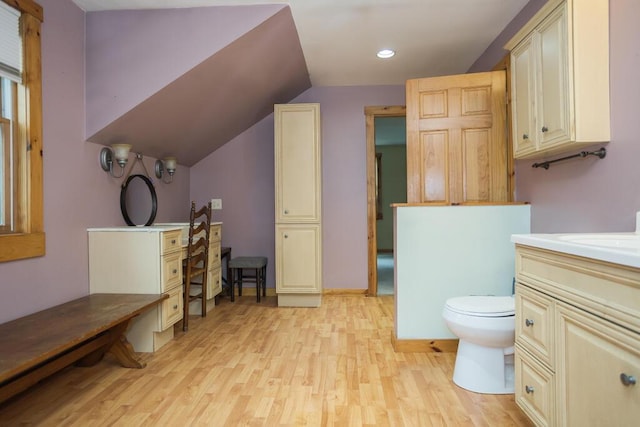 23 Orr St, Wilton, ME 04294 - bathroom with wood finished floors, vaulted ceiling, vanity, and recessed lighting
