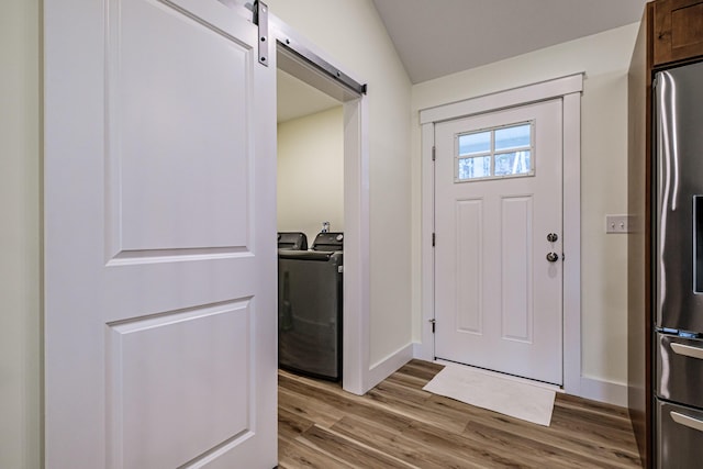15 Summit Dr, Bridgton, ME 04009 - entryway with independent washer and dryer, light wood finished floors, a barn door, and baseboards