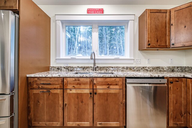 15 Summit Dr, Bridgton, ME 04009 - kitchen featuring stainless steel appliances, brown cabinetry, a sink, and a healthy amount of sunlight