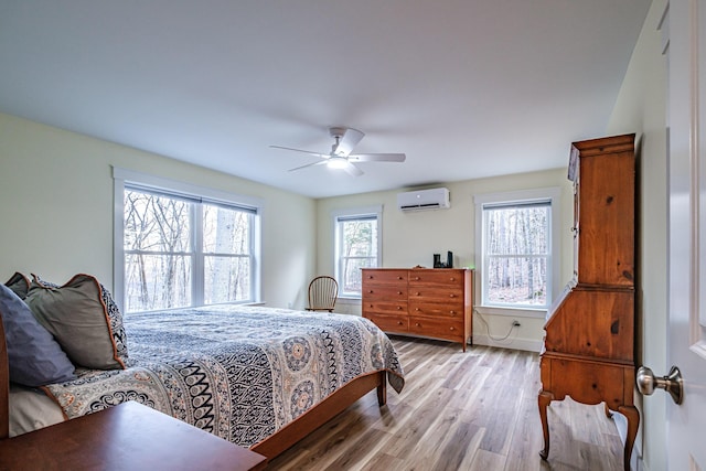 15 Summit Dr, Bridgton, ME 04009 - bedroom with light wood finished floors, a wall mounted air conditioner, ceiling fan, and baseboards