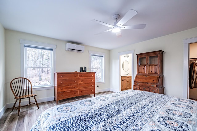 15 Summit Dr, Bridgton, ME 04009 - bedroom featuring wood finished floors, a wall mounted air conditioner, baseboards, and a ceiling fan