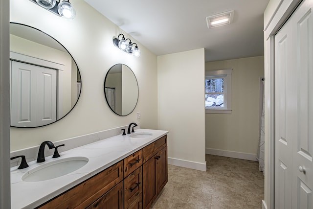 15 Summit Dr, Bridgton, ME 04009 - bathroom with double vanity, a sink, and baseboards