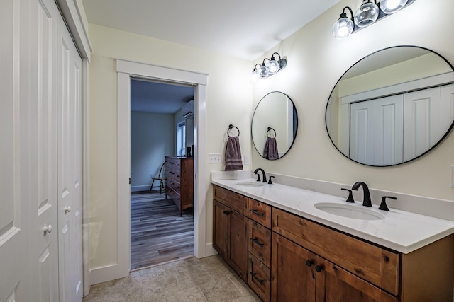 15 Summit Dr, Bridgton, ME 04009 - bathroom with double vanity, baseboards, and a sink