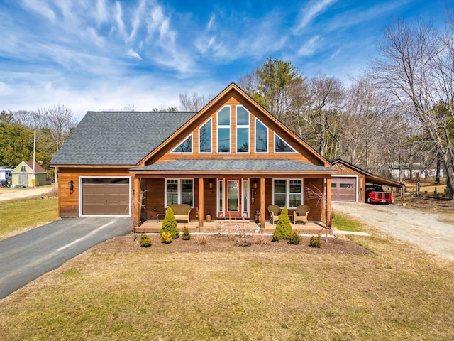 87 River Rd, Topsham, ME 04086 - view of front of home featuring roof with shingles, driveway, a front lawn, a garage, and covered porch