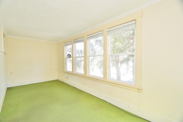 unfurnished room with carpet, ornamental molding, and a healthy amount of sunlight