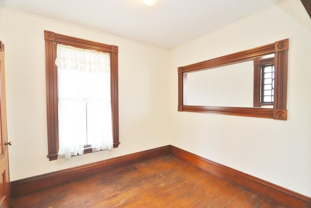 unfurnished room with wood-type flooring and baseboards