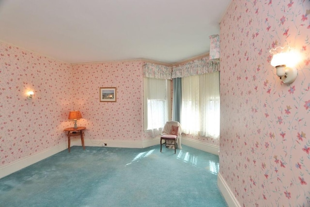 sitting room featuring wallpapered walls and carpet
