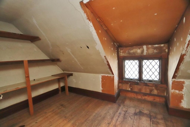 bonus room featuring wood-type flooring and vaulted ceiling
