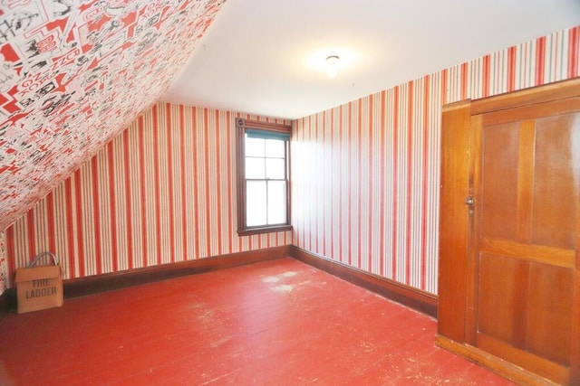 bonus room featuring vaulted ceiling, wood finished floors, and wallpapered walls