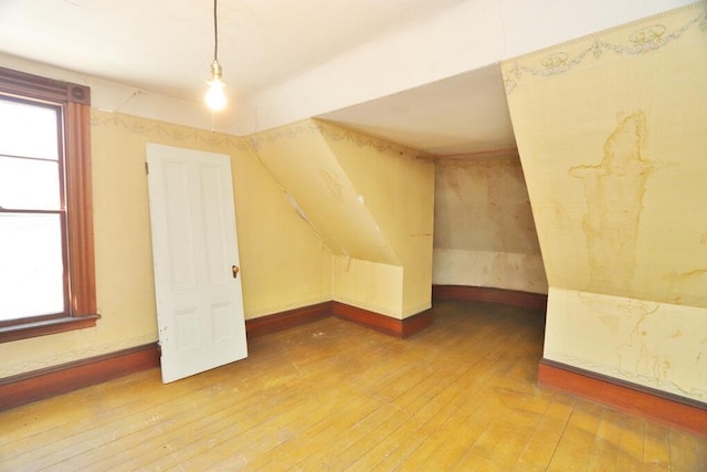 bonus room featuring hardwood / wood-style floors and plenty of natural light