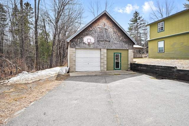 garage with a detached garage and driveway