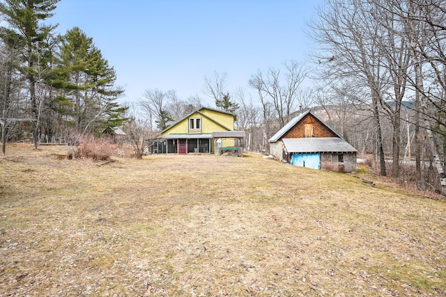 view of yard featuring an outbuilding, a garage, and a barn
